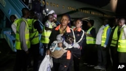 Nigerian returnees from Libya disembark from a plane upon arrival at the Murtala Muhammed International Airport in Lagos, Nigeria, Dec. 5, 2017. 