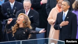 Beyonce sings the National Anthem as President Barack Obama (R) and Senator Charles Schumer (D-NY) listen during swearing-in ceremonies on the West front of the U.S. Capitol, Jan. 21, 2013. 