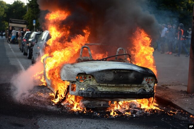 A car burns during a protest against the upcoming G-20 summit in Hamburg, Germany, July 6, 2017.