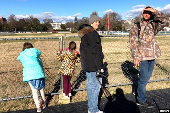 Tourists and visitors are unable to visit the National Christmas Tree near the White House in Washington because of its closure by the National Park Service, Dec. 22, 2018. The closure was made necessary by a partial federal government shutdown.