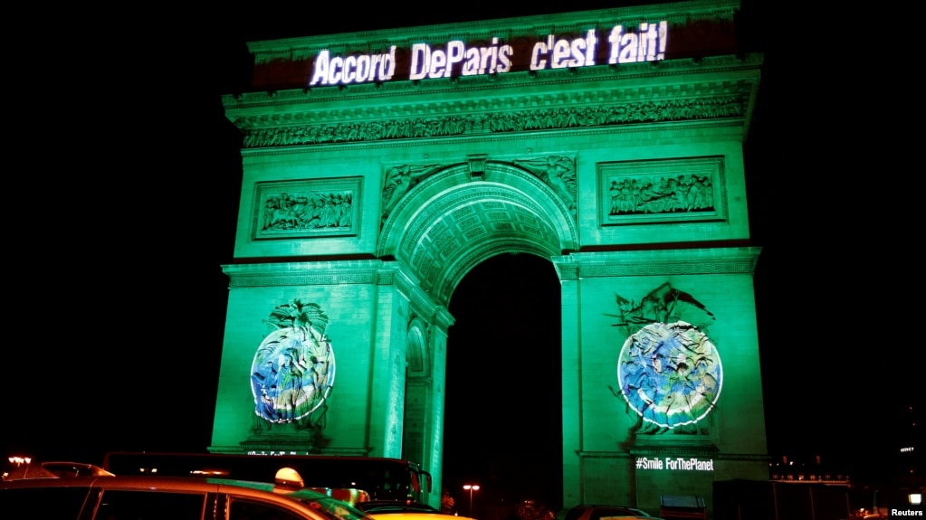 FILE - The Arc de Triomphe is illuminated in green with the words "Paris Agreement is Done," to celebrate the Paris U.N. COP21 Climate Change agreement in Paris, France, Nov. 4, 2016.