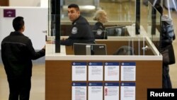 Travelers pass through U.S. Customs and Immigration after using the Cross Border Xpress pedestrian bridge between San Diego and the Tijuana airport on the facility's opening day in Otay Mesa, California, Dec. 9, 2015. 