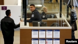 Travelers pass through U.S. Customs and Immigration after using the Cross Border Xpress pedestrian bridge between San Diego and the Tijuana airport on the facility's opening day in Otay Mesa, California, Dec. 9, 2015. The United States has expanded its counter-terrorism travel restrictions and is now excluding foreign visitors who have recently traveled to Libya, Somalia or Yemen from the visa waiver program.