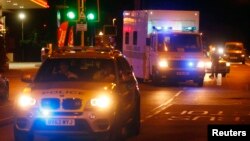 Police escort a Royal Armed Forces (RAF) ambulance carrying a British man infected with the Ebola virus after he was flown home on a C17 plane from Sierra Leone, at Northolt air base outside London, August 24, 2014.