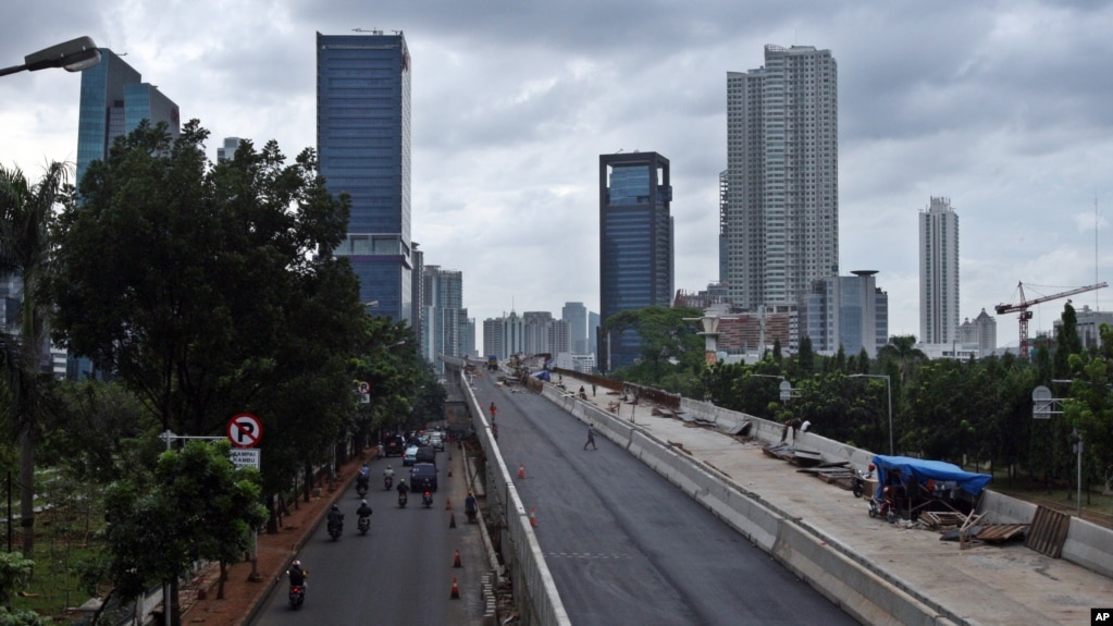 FILE - In this Jan. 11, 2013 photo, workers build an elevated highway in Jakarta, Indonesia. (AP Photo/Achmad Ibrahim)