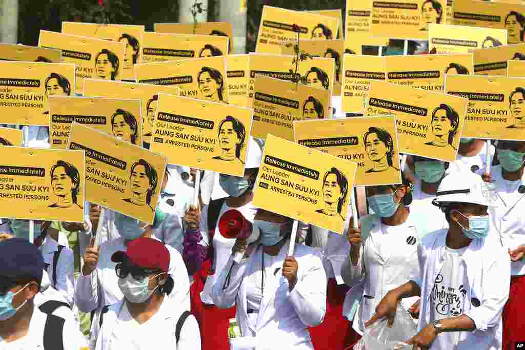 Medicals students display images of deposed Myanmar leader Aung San Suu Kyi during a street march in Mandalay, Myanmar. By midday, security forces had blocked the main road in downtown Mandalay to prevent the protesters from gathering.