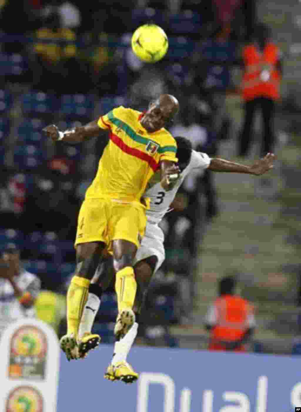 Mali's Berthe Abdoulaye Youssef (L) challenges Gyan Asamoah of Ghana during their African Cup of Nations Group D soccer match in FranceVille Stadium January 28, 2012.