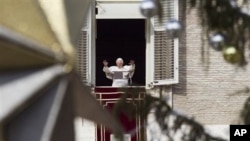 Pope Benedict XVI delivers his blessing during the Angelus noon prayer he celebrated from the window of his studio overlooking St. Peter's square at the Vatican, 26 Dec 2010.