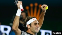 Switzerland's Roger Federer celebrates after winning his men's singles final match against Spain's Rafael Nadal at the Australian Open, Jan. 29, 2016.