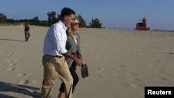 Romeny walks with his wife by lake Michigan after campaign act.