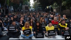 The students of Ankara University hold the placards with the names of those killed in Saturday's deadly explosions during a sit-in protest in Ankara, Turkey, Oct. 13, 2015. 