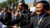 Opposition leader of Cambodia National Rescue Party Sam Rainsy, center, delivers a speech next to his Deputy President Kem Sokha, right, during a gathering to mark Human Rights Day, in front of National Assembly, in Phnom Penh, Cambodia, Wednesday, Dec. 10, 2014. (AP Photo/Heng Sinith)