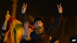 Kurds shout slogans to praise three women activists who were found shot dead in Paris, as ambulances, unseen, carry their coffins at an airport in Diyarbakir, Turkey, January 16, 2013.