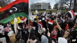 Protesters waving the 1951 first national flag of modern Libya gather in front of the White House in Washington, Saturday, Feb. 26, 2011 condemning Libyan leader Moammar Gadhafi and calling for his ouster.