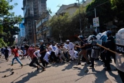 Police clash with Muslim devotees during a protest over an alleged insult to Islam, outside the country’ main Baitul Mukarram Mosque in Dhaka, Bangladesh, Oct. 15, 2021.