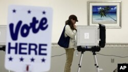 Voter from White Haven, Md., casts ballot at a polling place in Salisbury, Md., Oct. 31, 2012, after superstorm Sandy passed through the area.