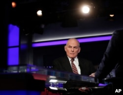 White House chief of staff John Kelly pauses to look to a video monitor as he appears with Bret Baier on Fox News in Washington, Jan. 17, 2018. Kelly said President Donald Trump's views on many issues had evolved since the 2016 campaign.