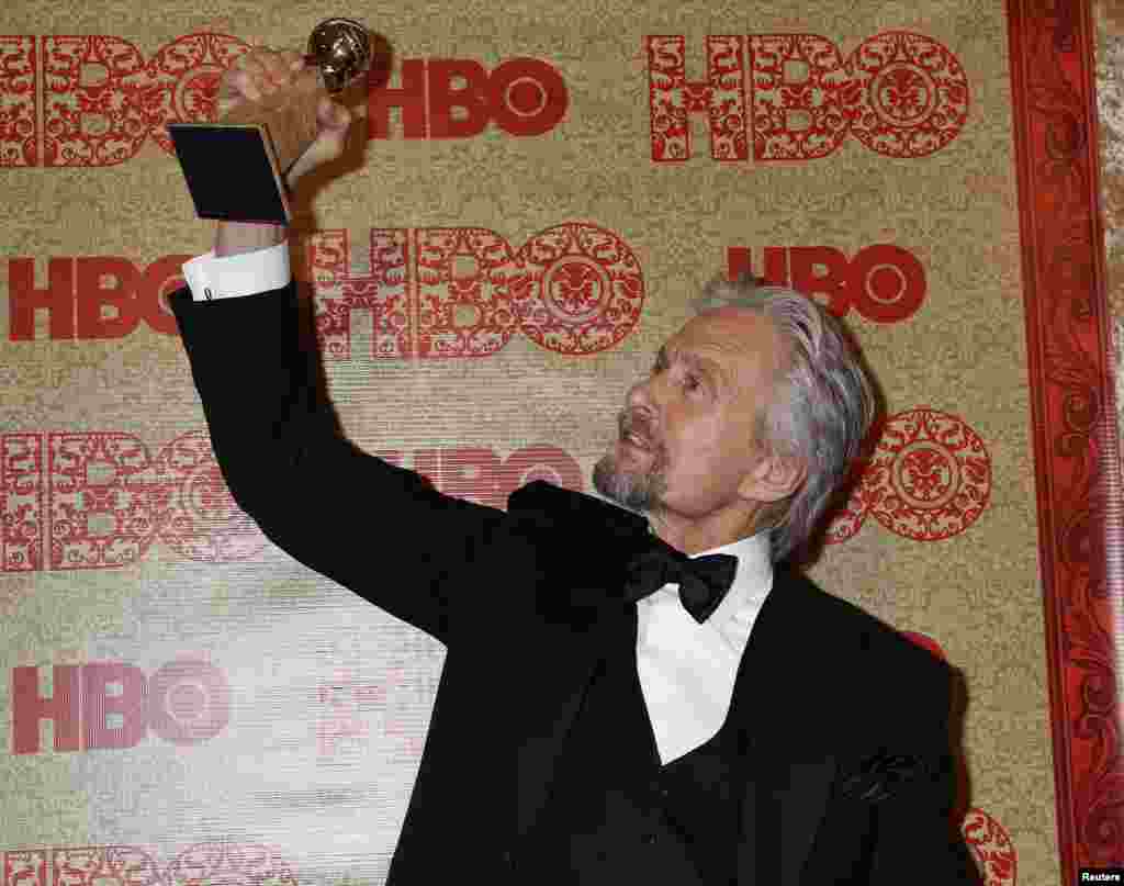 Michael Douglas holds the Golden Globe Award he won as Best Actor, Miniseries or Movie, for his role in HBO&#39;s &quot;Behind the Candelabra&quot; at the HBO after party, after the Golden Globe Awards, Jan. 12, 2014.