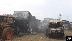 Trucks allegedly burned by communist rebels seen at the compound of Taganito Mining Corp, partly owned by a Japanese company, in Surigao del Norte province, southern Philippines on Tuesday Oct. 4, 2011.
