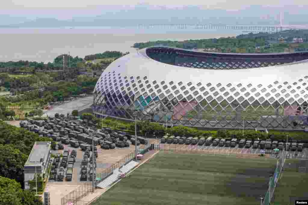 Military vehicles are seen parked on the grounds of the Shenzhen Bay Sports Center in Shenzhen, China.