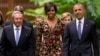 President Barack Obama, right, and first lady Michelle arrive for a state dinner with Cuba's President Raul Castro, left, at the Palace of the Revolution in Havana, March 21, 2016. 