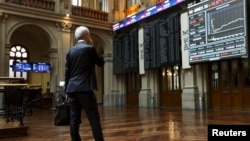 A trader looks at computer screens at Madrid's bourse, Spain, June 29, 2015. 