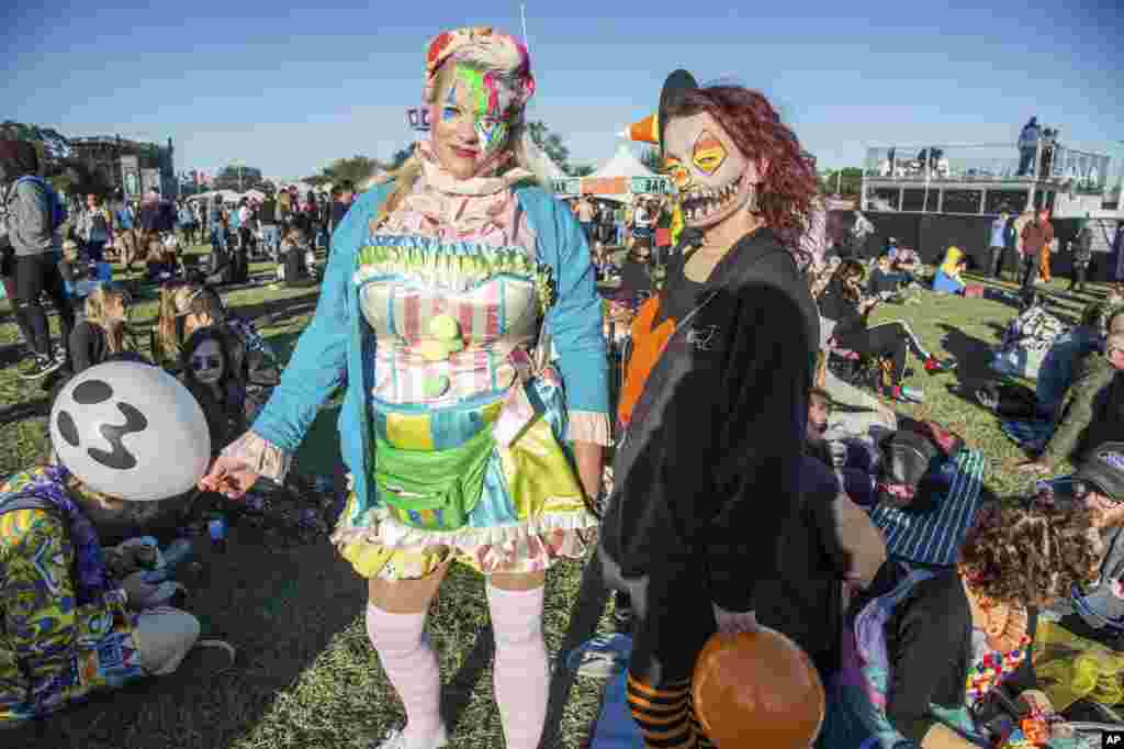 Festival goers in Halloween costumes attend the Voodoo Music Experience in City Park on Oct. 28, 2017, in New Orleans. 