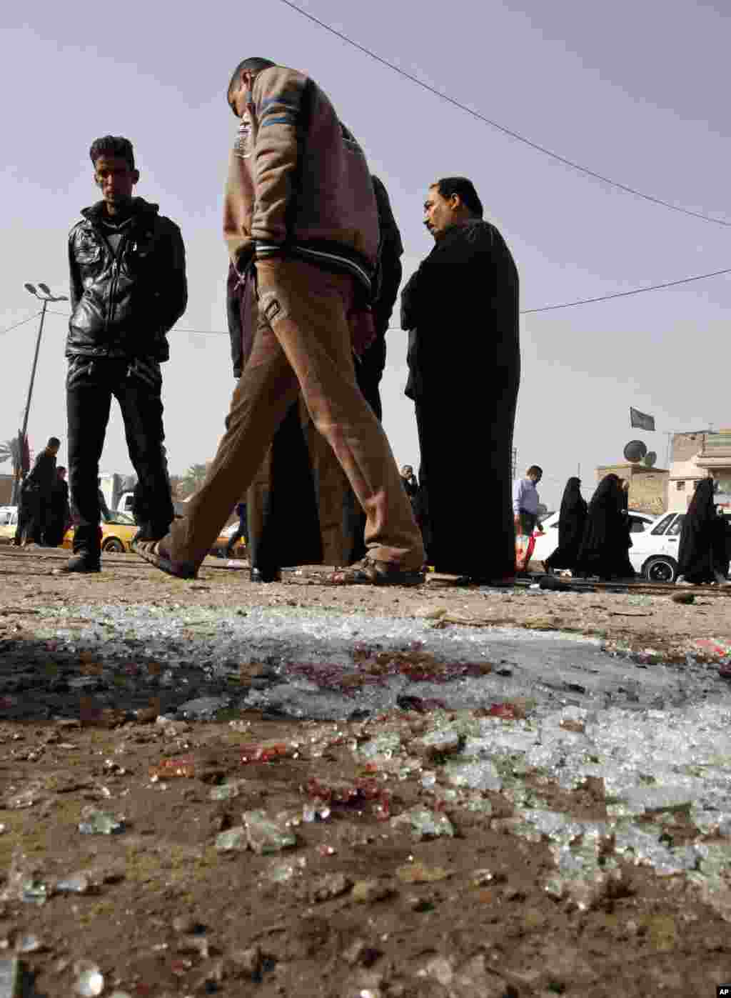 Broken glass remains at the scene of a suicide bomb attack at Adan Square, in a predominantly Shi&#39;ite part of Baghdad, Feb. 9, 2015.