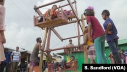Children enjoy a manual Ferris wheel ride during the Eid Al-Adha religious celebration at the Kutipalong refugee camp in Cox's Bazar this week.