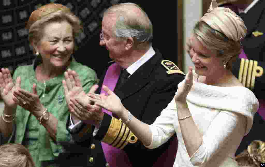 La reina Paola, el rey Alberto II y la nueva reina Mathilde aplauden el discurso del nuevo rey Felipe.