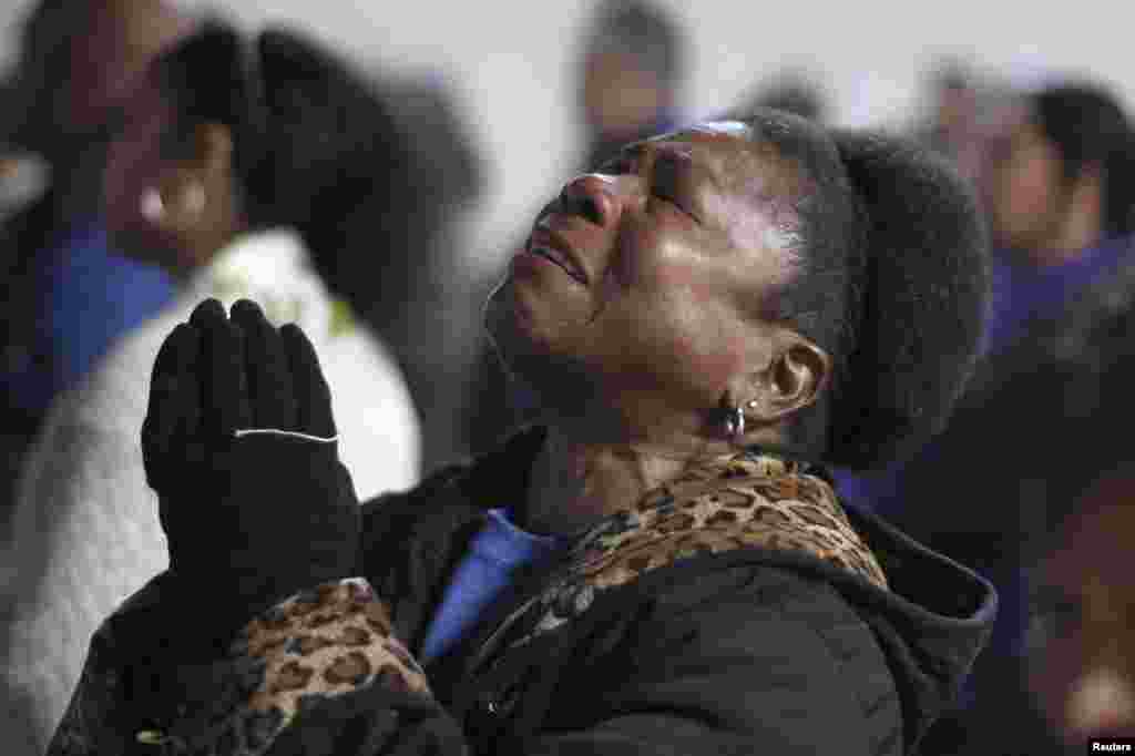 Pastora Munroe reacts as President Barack Obama takes the oath of office while black and Latino activists watch in Gardena, California, January 21, 2013