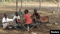 FILE - Children play with a broken playground chair in Kakuma refugee camp in northwestern Kenya. 