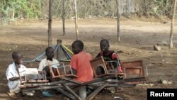 Sudanese children play with a broken playground chair in Kakuma Refugee camp, which houses over 60,000 refugees in North western Kenya. (File Photo)