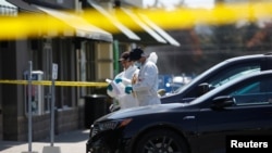 Police forensic investigators collect evidence at Bombay Bhel restaurant, where two unidentified men set off a bomb late Thursday night, wounding 15 people, in Mississauga, Ontario, Canada, May 25, 2018.