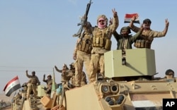 FILE - Iraqi security forces deploy in Rawah, northwest of Baghdad, Iraq, Nov. 17, 2017. Iraqi forces backed by the U.S.-led coalition retook the last town in the country that was held by the Islamic State group.