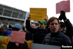 Protesters gather outside Terminal 4 at John F. Kennedy International Airport in Queens, New York, Jan. 28, 2017.