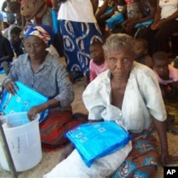Women hold mosquito nets after receiving them at a distribution point in Sesheke, Zambia (File Photo -30 Sep 2010)