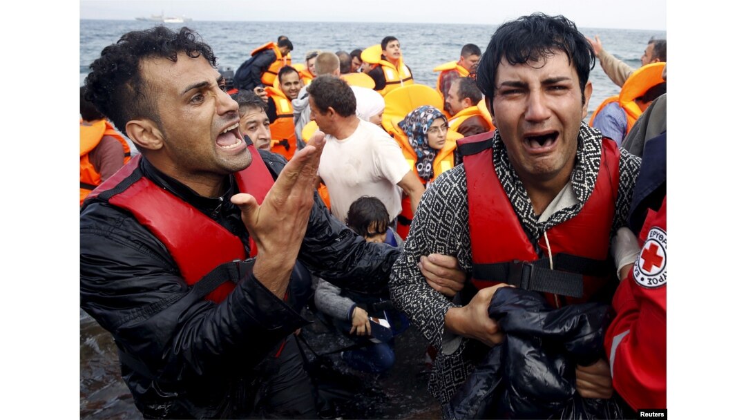 A Greek Red Cross volunteer comforts a crying Syrian refugee moments after disembarking from a flooded raft at a beach on the Greek island of Lesbos after crossing a part of the Aegean Sea from the Turkish coast by an overcrowded raft, Oct. 20, 2015.
