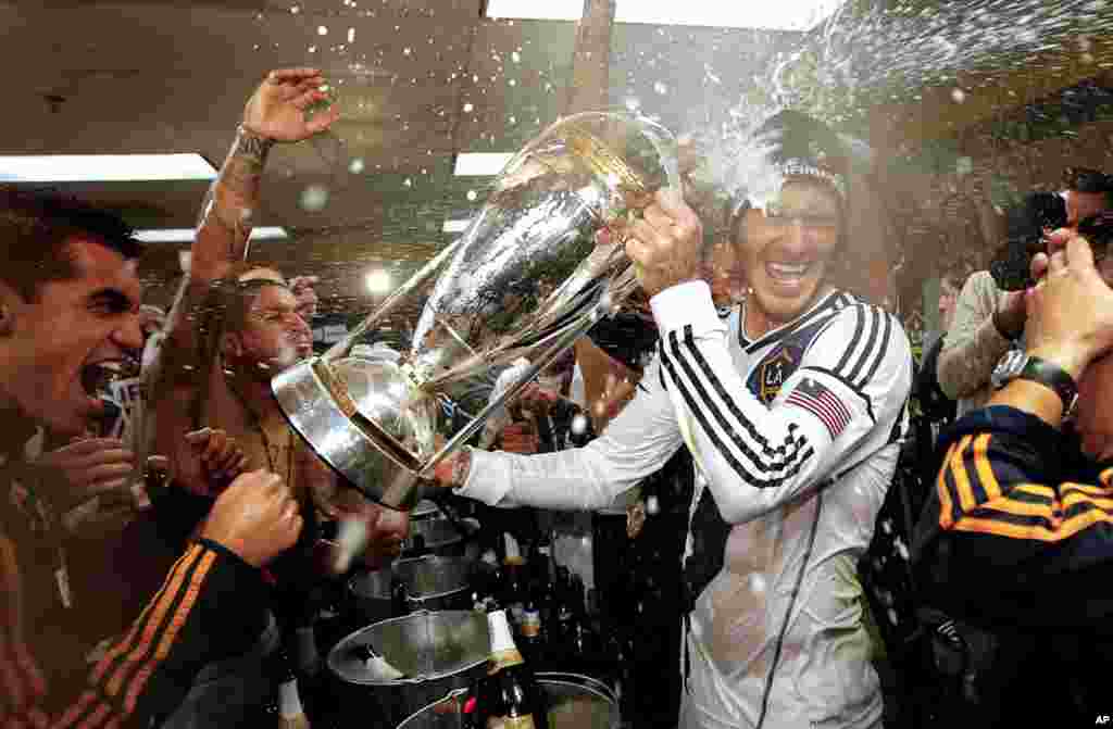 Beckham is sprayed with champagne as the LA Galaxy celebrate defeating the Houston Dynamo 3-1 in the MLS Cup championship soccer game in Carson, Calif., December 1, 2012.