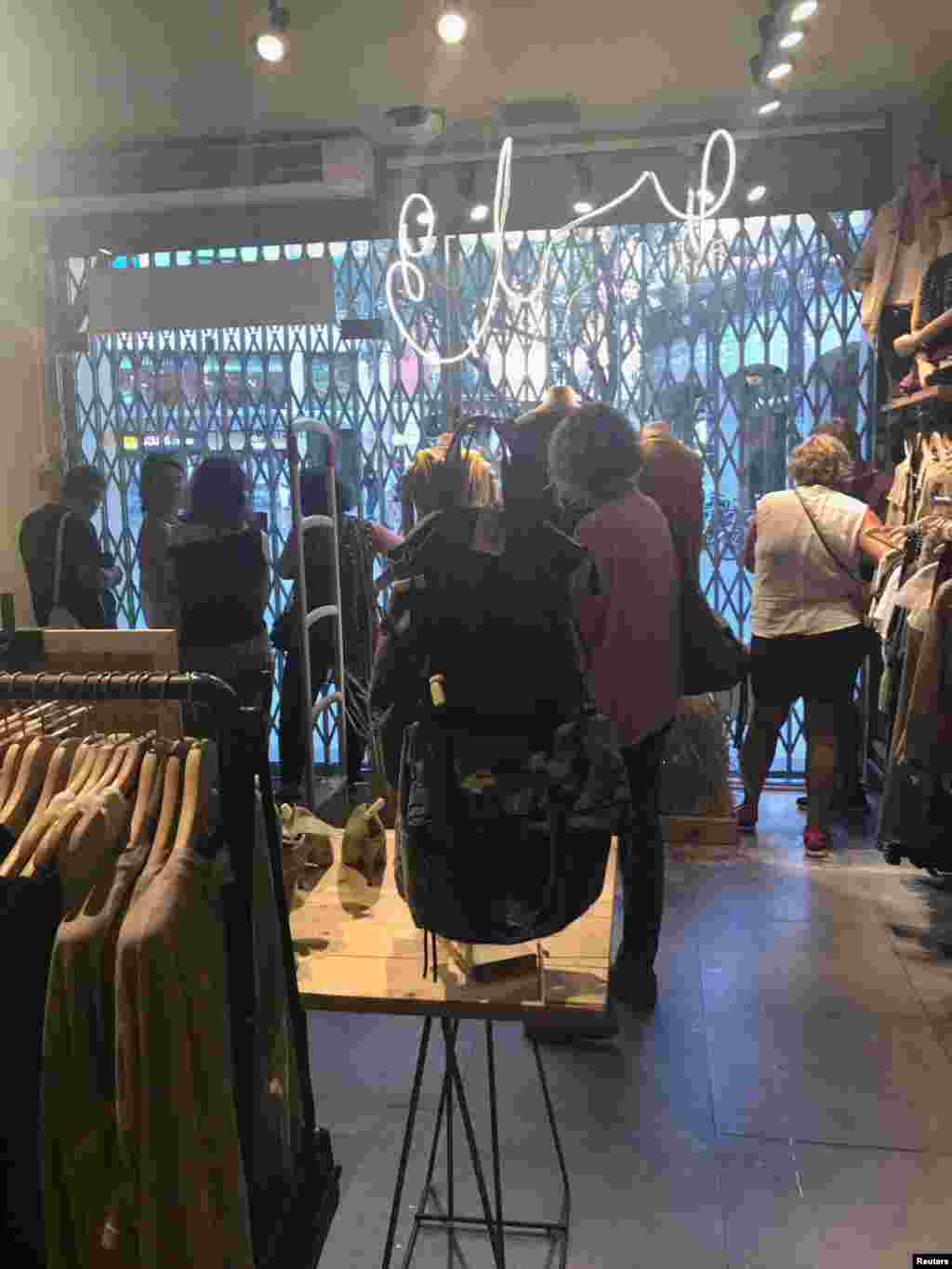 People are pictured inside Systemaction, a locked-down store, after a van crashed into crowds on Las Ramblas in Barcelona, Spain, Aug. 17, 2017. 