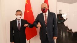 Chinese Foreign Minister Wang Yi, left, poses for a photo with Albanian Prime Minister Edi Rama in Tirana, Albania, Oct. 29, 2021.