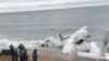 <div>People gather near the wreckage of a plane that crashed into the sea off Abidjan, Ivory Coast, Oct. 14, 2017. (VOA / Narita Namasté)</div>
