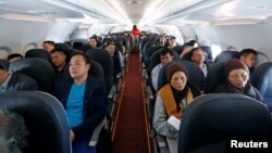 FILE - Passengers are seen during a flight of VietJet Air from Hanoi to Ho Chi Minh city, Vietnam, Jan. 12, 2018. 
