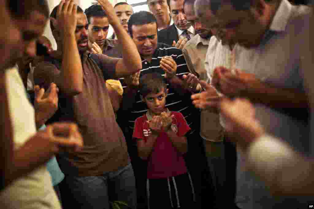 Son of the late Ammar Badie prays during his father&#39;s funeral in al-Hamed mosque in Cairo&#39;s Katameya district on Aug. 18, 2013. Badie, the son of Muslim Brotherhood&#39;s spiritual leader Mohammed Badie, was killed by Egyptian security forces Friday.