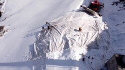 Employees of Titlis Bergbahnen cable car operator place blankets on parts of the glacier to protect it against melting on Mount Titlis near the Alpine resort of Engelberg, Switzerland July 2, 2021. (REUTERS/Arnd Wiegmann)