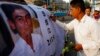 A Cambodian worker gives a signature on a poster of Chea Vichea during the 11th anniversary of the assassination of Chea Vichea, former head of Cambodia's Free Trade Union of Workers, in Phnom Penh, Cambodia, Thursday, Jan. 22, 2015. (AP Photo/Heng Sinith)