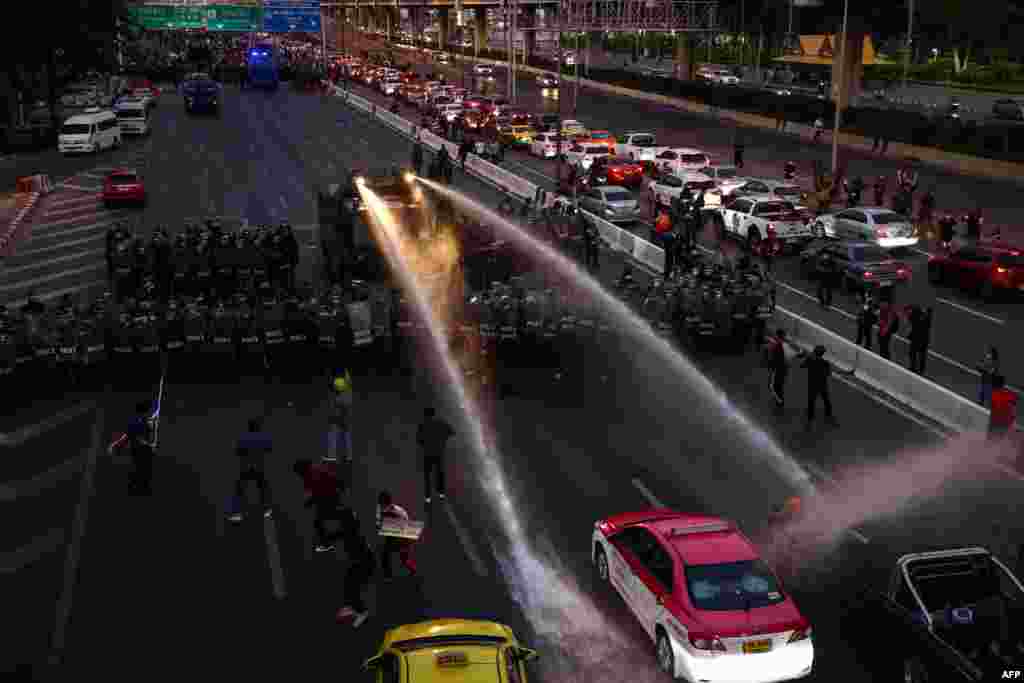 Police us a water cannon to disperse pro-democracy protesters marching toward the residence of Thailand&#39;s Prime Minister Prayut Chan-O-Cha in Bangkok.