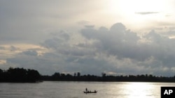 A fishing boat floats on the Mekong river at Sambor in Cambodia's Kratie Provice, another site in the country that has been chosen for a proposed 18-kilometer hydro-dam.