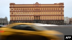 FILE - Cars drive past the headquarters of the Russian Federal Security Service (FSB) in central Moscow on Dec. 30, 2016. A massive Yahoo breach exposes the intertwining of Russian security services and the country’s murky digital underworld, a U.S. indictment alleges.
