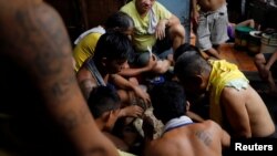 Detaines eat their food rations inside the city jail of Quezon City, Metro Manila, Philippines, July 8, 2017.